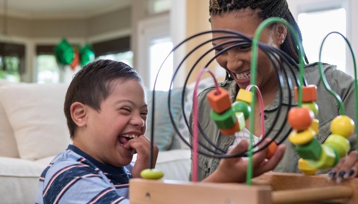 infant and therapist working on bead maze