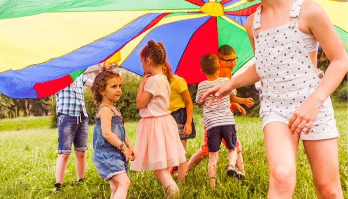Kids playing under a parachute