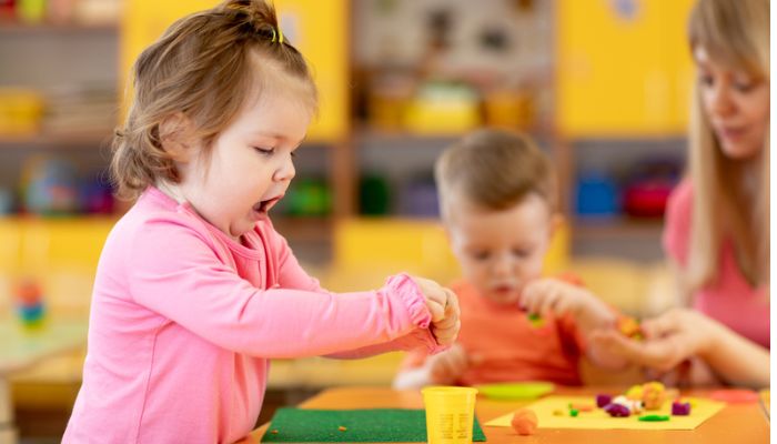infant preschooler playing with play doh