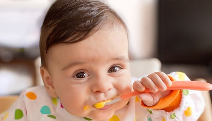 baby eating with spoon
